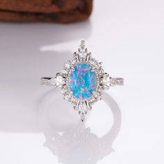 Mesmerizing Fire in Sterling Silver: Mia Ring. This handcrafted ring features a captivating natural blue fire opal, its brilliance flickering with every move. A timeless treasure that adds a touch of magic to any outfit (sizes 3.5-14.25). ✦ DETAILS ✦ ✧ Handcrafted  ✧ Fire opal and natural crystals  ✧ Sizes 3.75-14.25 ✧ This ring  will arrive ready to gift in a Kherish Jewelry Pouch. ✧ Due to the nature of the handmade process, each piece may slightly vary in color, size, shape, and contain natur Pretty Wedding Rings, Renew Vows, Blue Opal Ring, Blue Fire Opal, Fire Opal Ring, Jewelry Design Inspiration, Jewelry Dainty, Handcrafted Rings, Blue Fire