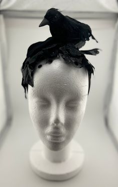 This black crow fascinator will step up your Halloween costume game. Pair it with an LBD, and all black outfit, or anything for that matter! You'll be the talk of the party...in the best way! This Fascinator is made with an artificial crow, glittered artificial leaves, black polka dot tulle, satin ribbon, and a satin headband. Everything is secured to the headband. The crow on this Fascinator is a bit smaller than the other posted crow fascinator.   This item was made in a smoke free home that i Witchy Winter Party Costume Hats And Headpieces, Black Fitted Fascinator For Evening, Fitted Black Fascinator For Evening, Black Fitted Fascinator For Party, Fitted Black Fascinator For Party, Fitted Black Headpiece For Evening, Black Gothic Mini Hats For Costume Party, Black Costume Accessories For Winter Cosplay, Black Costume Accessories For Cosplay In Winter