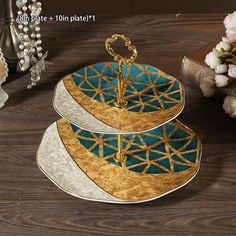 three plates stacked on top of each other with gold trimmings and blue designs