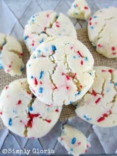 white cookies with red, white and blue sprinkles are on a table