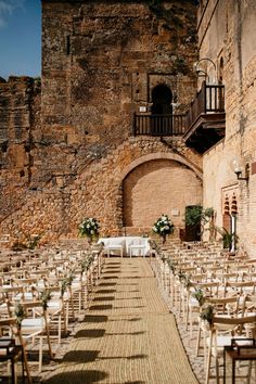 an outdoor ceremony setup with chairs and tables