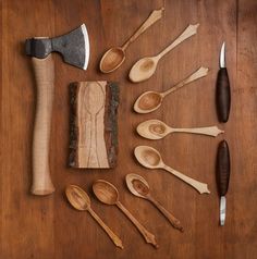 various wooden spoons and knives laid out on a table