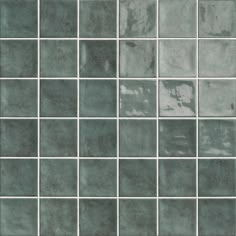 an image of a tile wall that looks like it has been painted in shades of green