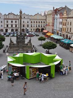 an aerial view of a city square with people walking around