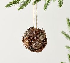 a pine cone ornament hanging from a christmas tree