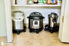 two crockpots sitting next to each other on top of a kitchen floor