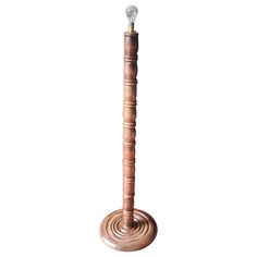 a tall wooden pole with a light on it's end and a white background