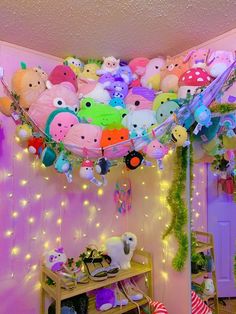 a room filled with lots of stuffed animals hanging from the ceiling and decorations on the wall