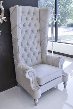 a white chair sitting in front of a window