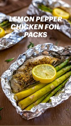 lemon pepper chicken foil packs with asparagus and lemons on the side in tinfoil