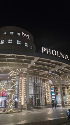 the entrance to a building that has lights on it