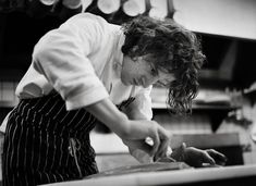 a woman is preparing food in the kitchen