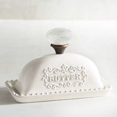 a white cake dish with the words happy birthday on it