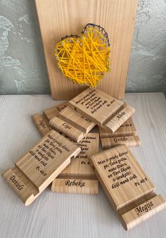 several wooden coasters with yellow string attached to them, sitting on top of a table