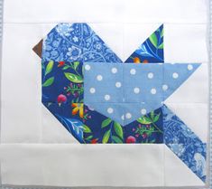 an origami bird made out of blue and white fabric