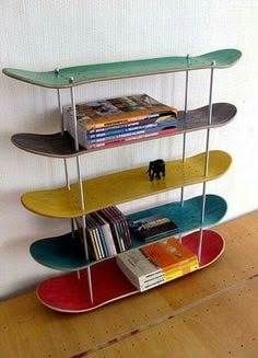 three skateboards are stacked on top of each other in the shape of bookshelves