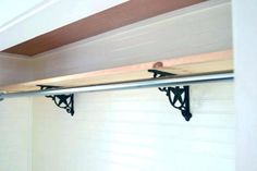 a garage door with two brackets attached to the side of it and a shelf below