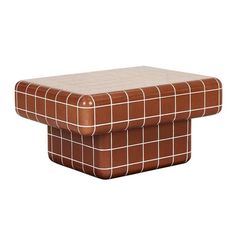 a brown and white checkered ottoman sitting on top of a table