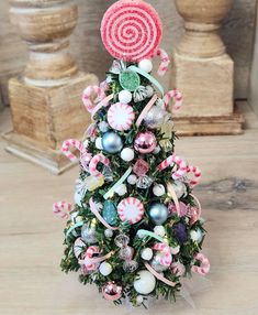 a christmas tree decorated with candy canes and candies on it's top