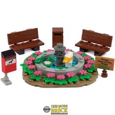 a lego model of a park with benches and flowers