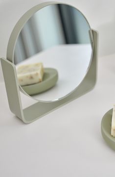 two pieces of food sitting on plates in front of a mirror