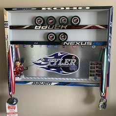 a display case with hockey memorabilia and medals hanging from it's sides on the wall