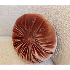 a round cushion on the back of a couch