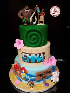 a birthday cake with an ema theme on it's top and two figurines