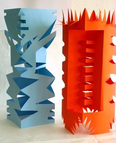 two paper sculptures made to look like they have spikes on them