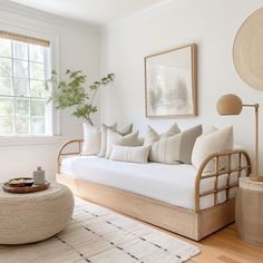 a living room filled with lots of white furniture