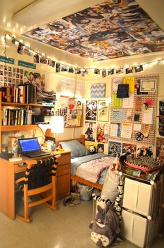 the room is decorated with many pictures and posters on the ceiling, along with other items