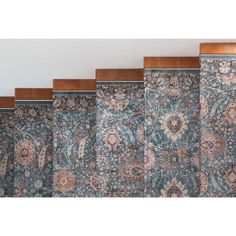 four different types of rugs lined up against the wall