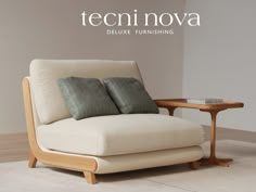 a white chair with two pillows on it in front of a coffee table and wall