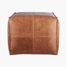 a large brown leather ottoman on a white background