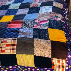 a bed covered in lots of colorful patchwork