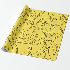 a yellow wrapping paper with black bananas on it