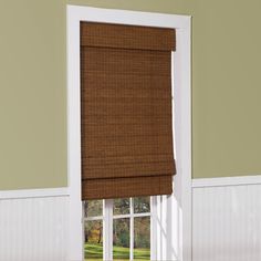 an open window with a brown roman blind