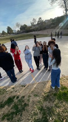 a group of people taking pictures with their cell phones