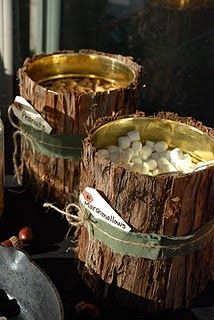 two wooden bowls filled with marshmallows sitting on top of a table next to other items