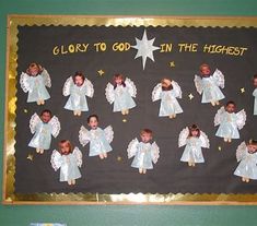 a bulletin board with angels and stars on it that says glory to god in the highest