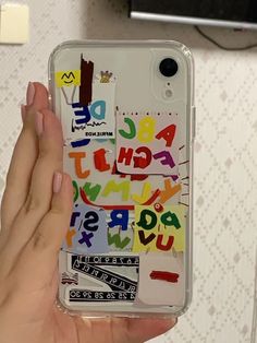 someone is holding up their phone case with letters on it