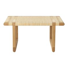 a small wooden table with two legs and a wicker design on the top, against a white background