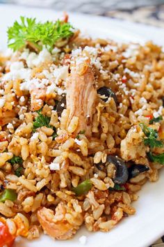 a white plate topped with rice and vegetables