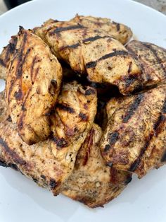 grilled chicken on a white plate ready to be eaten