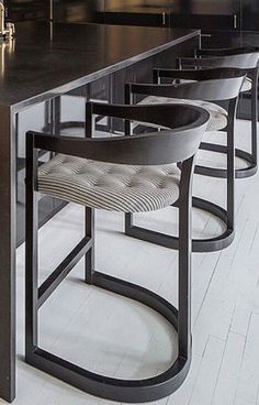 a row of chairs sitting at a counter in a kitchen