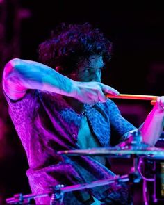 a man playing the drums on stage