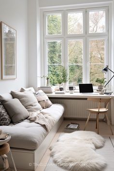 a living room filled with furniture and windows