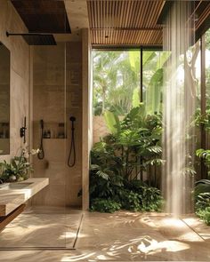 a bathroom with a shower, sink and plants