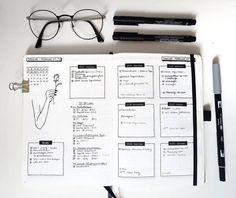 an open planner with glasses and pens on it