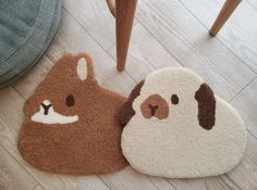 two brown and white animal rugs sitting on top of a wooden floor next to a chair